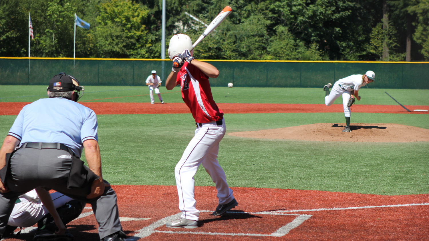 Baseball flies through the air towards batter at one of Eastlake Community Fields.